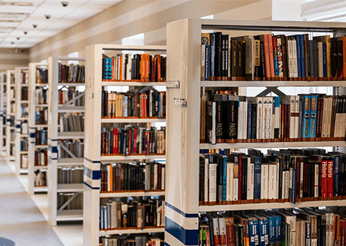 Library with multiple book shelves that are full of books.